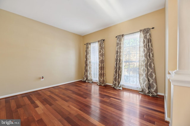 spare room featuring dark hardwood / wood-style floors