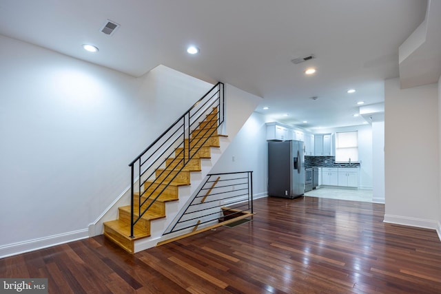 staircase featuring hardwood / wood-style flooring