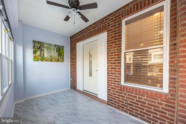 view of exterior entry with covered porch and ceiling fan