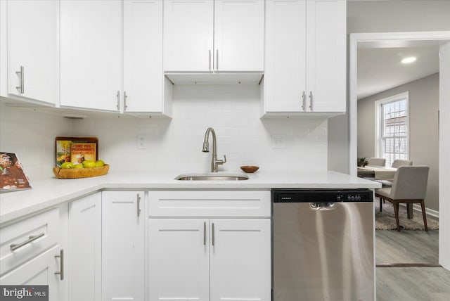 kitchen with white cabinets, stainless steel dishwasher, and sink