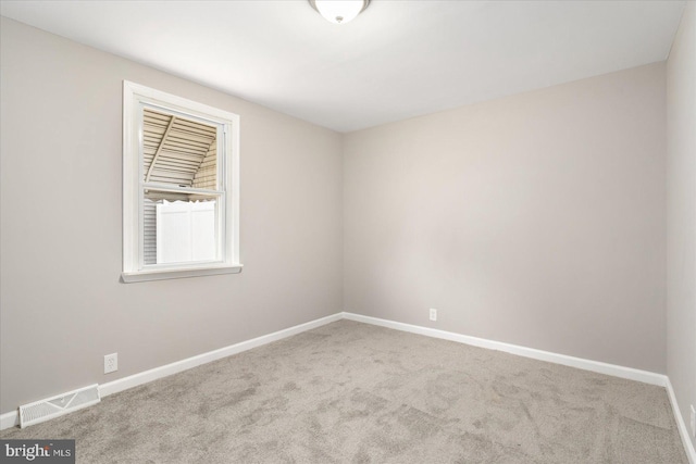 empty room with light colored carpet