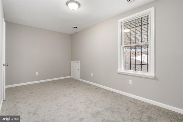 unfurnished room featuring light colored carpet