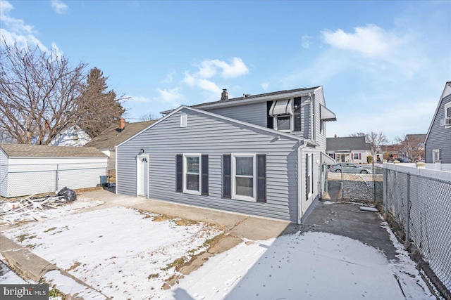 view of snow covered rear of property