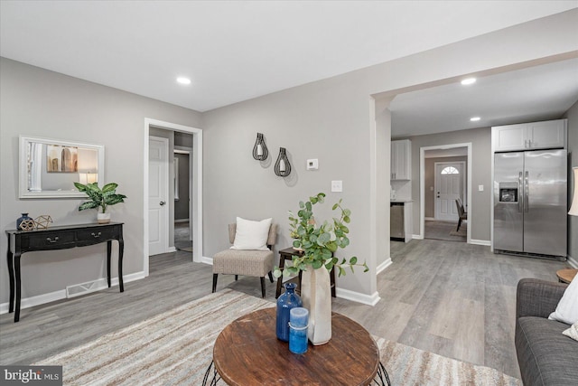 living room with light hardwood / wood-style flooring