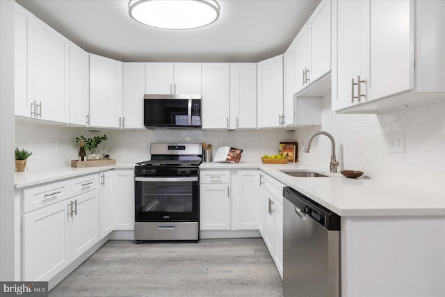 kitchen featuring sink, white cabinets, and appliances with stainless steel finishes