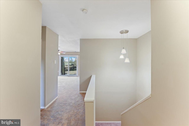 hallway featuring light carpet