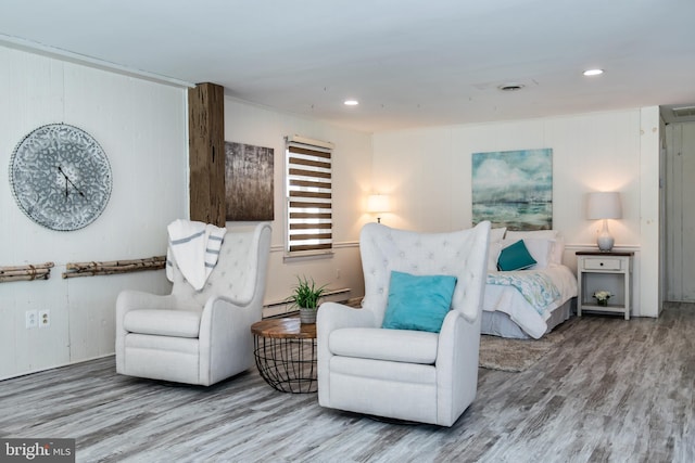 interior space featuring a baseboard radiator and hardwood / wood-style flooring