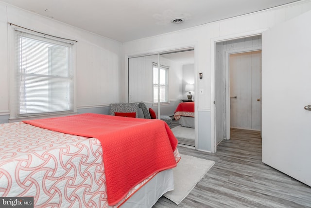 bedroom featuring light wood-type flooring and a closet