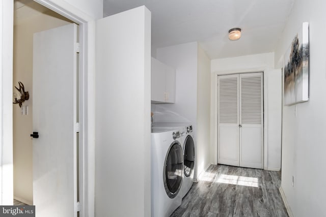 clothes washing area featuring independent washer and dryer, cabinets, and hardwood / wood-style floors