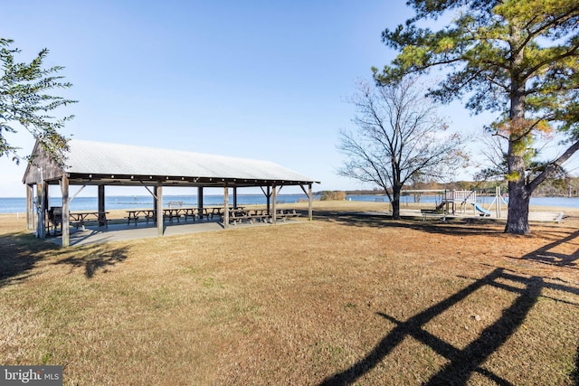 exterior space with a playground and a water view