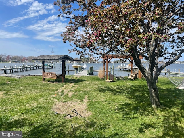 view of yard featuring a dock and a water view