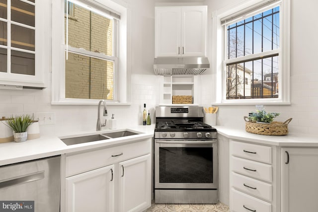 kitchen with sink, stainless steel gas range oven, white cabinetry, tasteful backsplash, and dishwashing machine