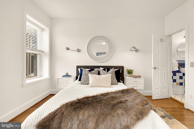 bedroom with hardwood / wood-style flooring