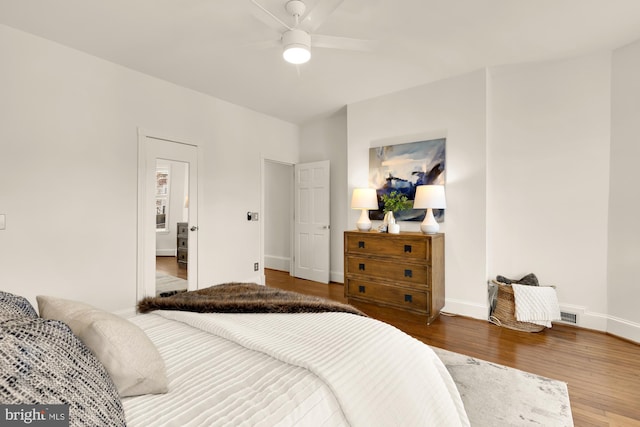 bedroom with hardwood / wood-style floors and ceiling fan