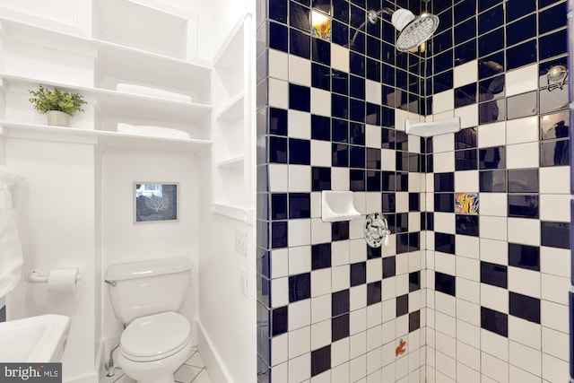 bathroom featuring toilet and tiled shower