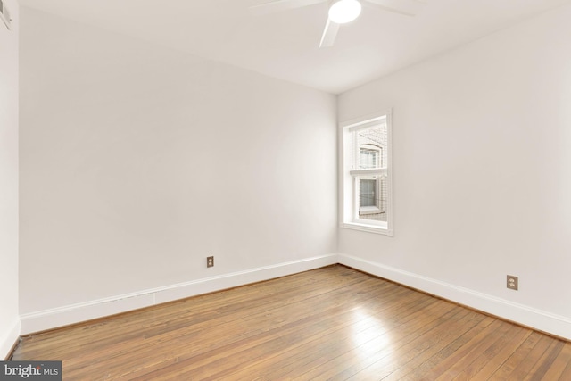 empty room with hardwood / wood-style flooring and ceiling fan