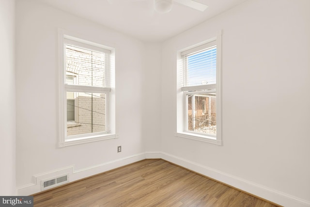 unfurnished room with light hardwood / wood-style flooring, plenty of natural light, and ceiling fan