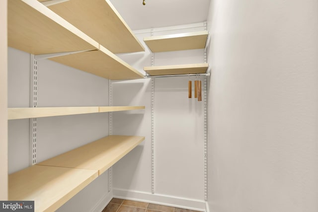 spacious closet featuring light tile patterned floors