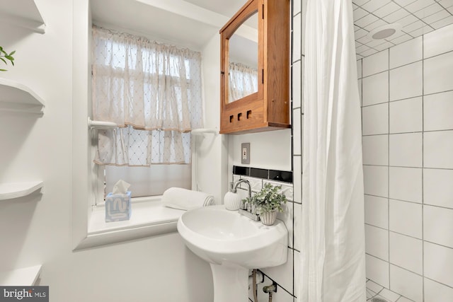 bathroom featuring sink and curtained shower