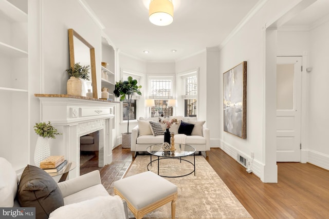 living room featuring ornamental molding and wood-type flooring