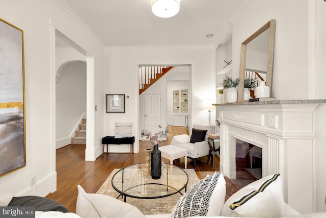 living room featuring dark wood-type flooring and ornamental molding