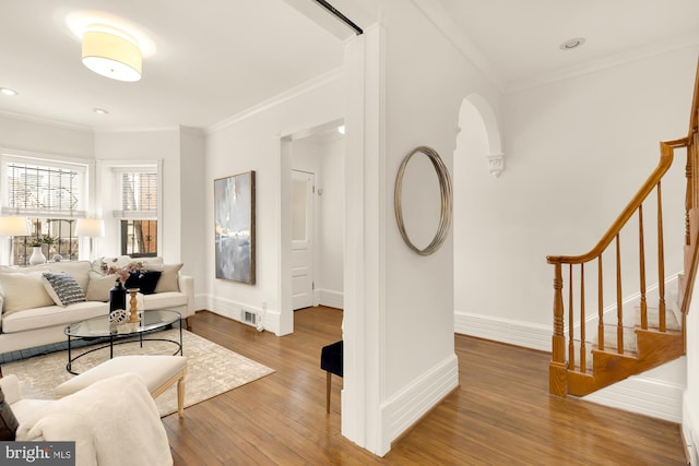 living room featuring hardwood / wood-style floors and crown molding