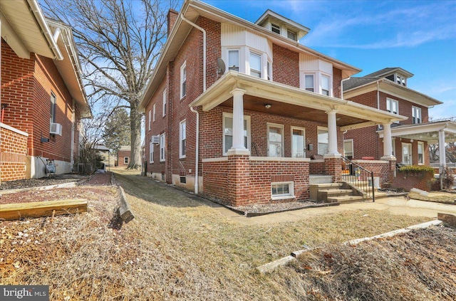 view of front of home with covered porch and brick siding