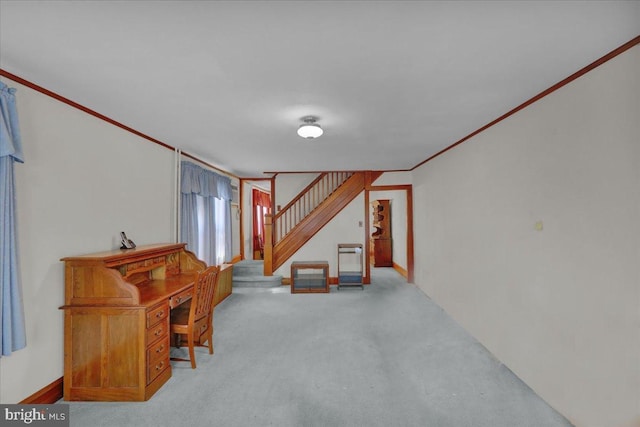 below grade area featuring light colored carpet, crown molding, and stairway