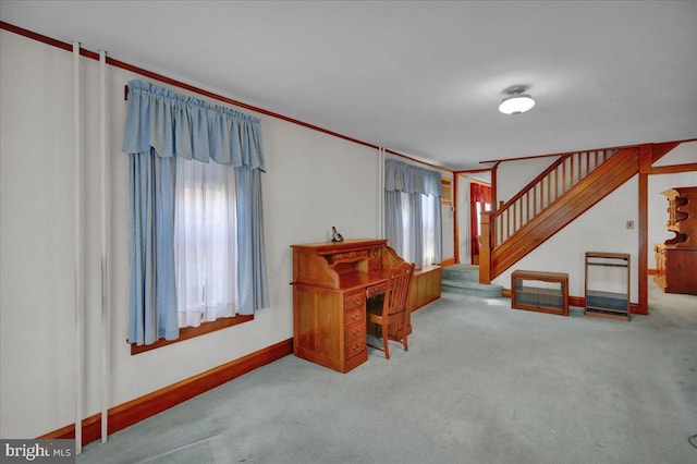 carpeted home office with ornamental molding and baseboards