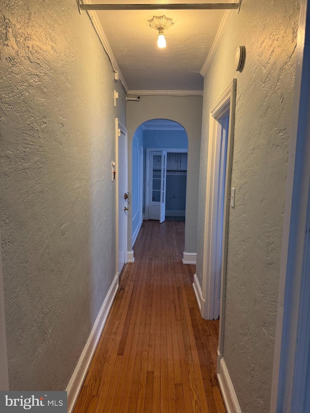 hall featuring dark hardwood / wood-style flooring and crown molding