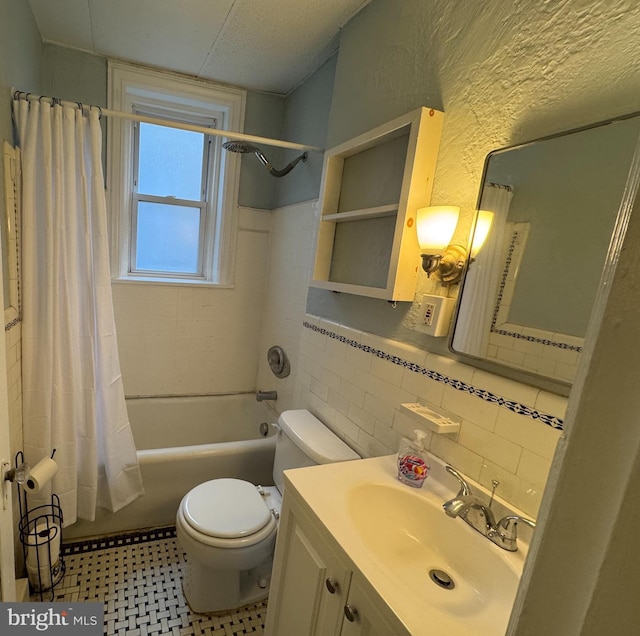 full bathroom with toilet, tile walls, shower / bath combination with curtain, and vanity