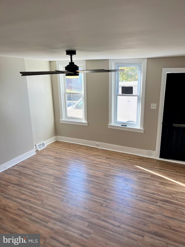 unfurnished room with wood-type flooring