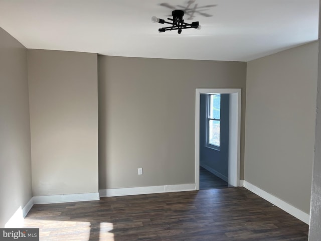 spare room featuring ceiling fan and dark hardwood / wood-style flooring