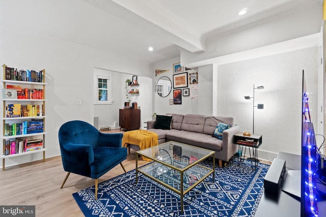 living room with beam ceiling, hardwood / wood-style floors, and ornamental molding