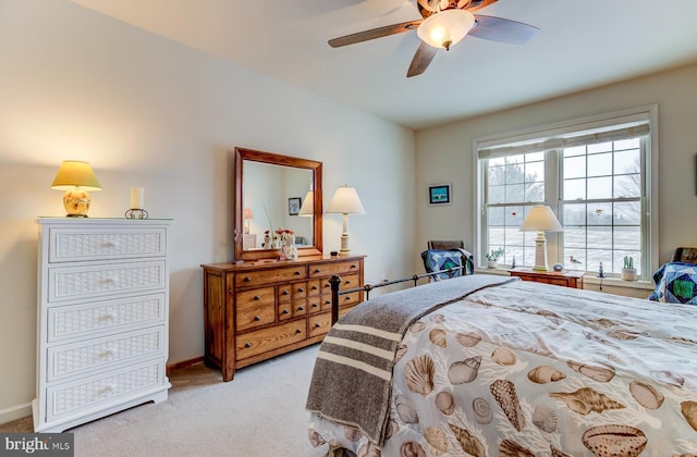 bedroom featuring light carpet and ceiling fan