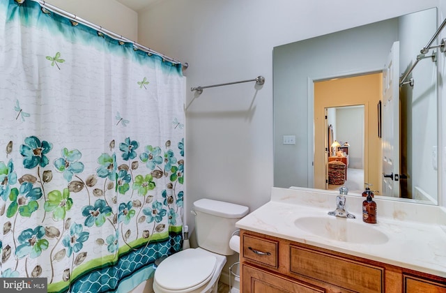 bathroom featuring toilet and vanity