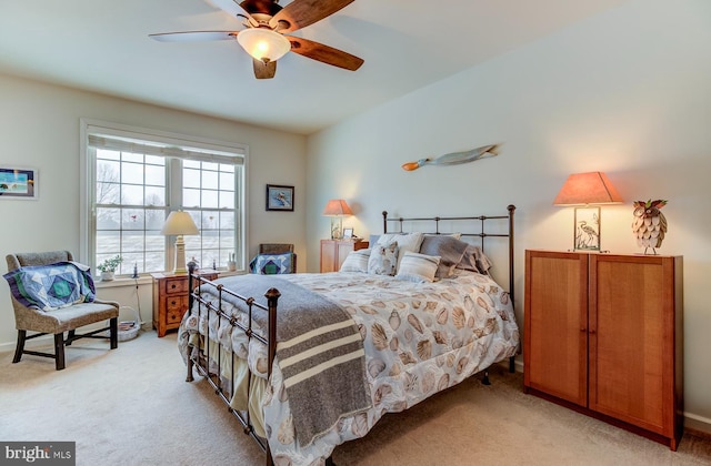 bedroom featuring ceiling fan and light carpet