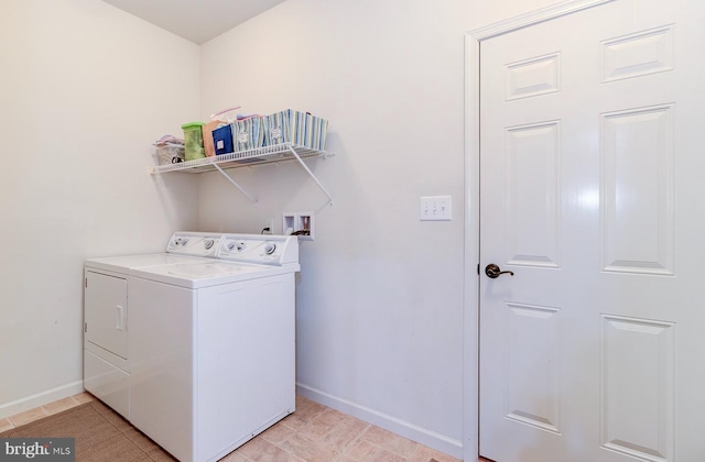 laundry area featuring light tile patterned flooring and separate washer and dryer