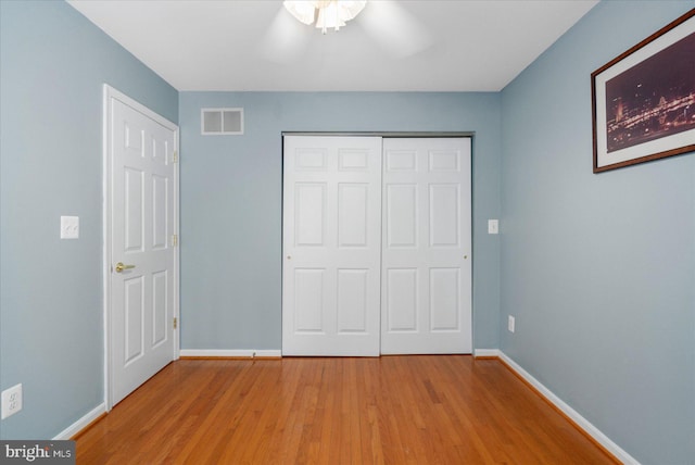 unfurnished bedroom featuring a closet, ceiling fan, and light hardwood / wood-style floors