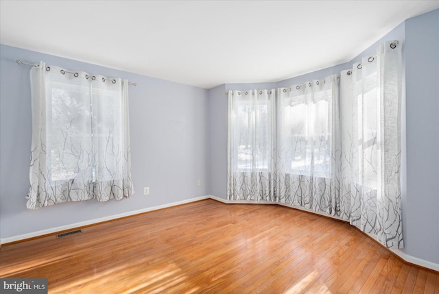 empty room with hardwood / wood-style flooring