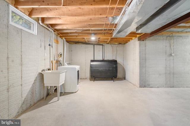 basement with sink and washer / dryer