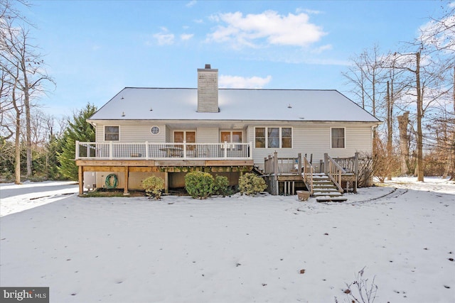 snow covered property featuring a wooden deck