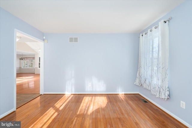 unfurnished room with hardwood / wood-style floors