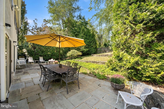 view of patio / terrace with outdoor dining area and fence