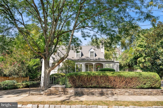 cape cod house with fence