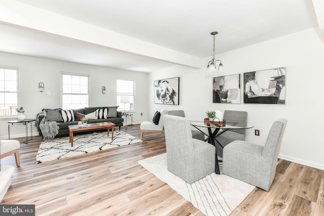 dining space featuring a notable chandelier and light hardwood / wood-style floors