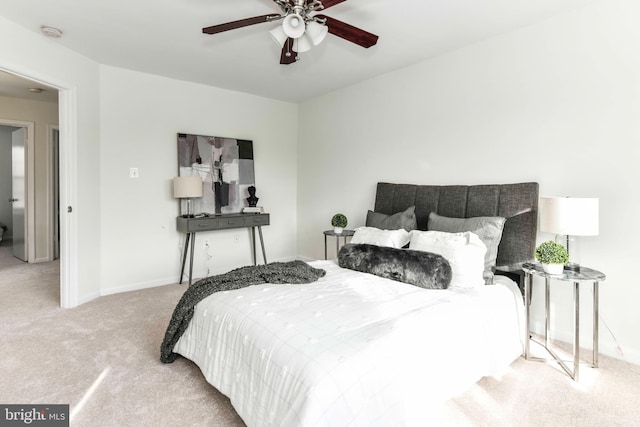 bedroom with ceiling fan and light colored carpet