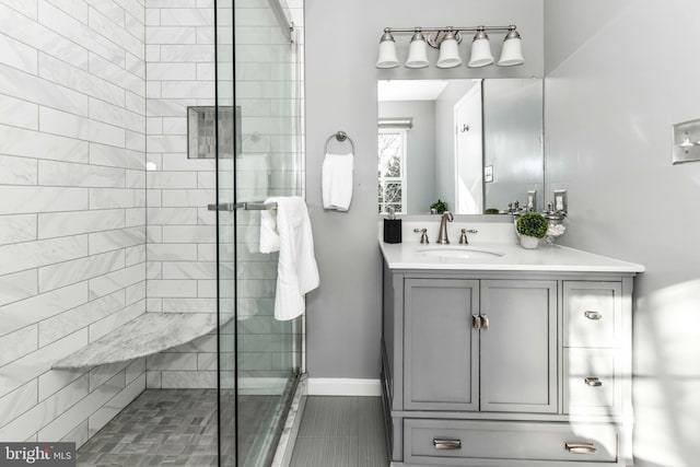 bathroom with a shower with door and vanity