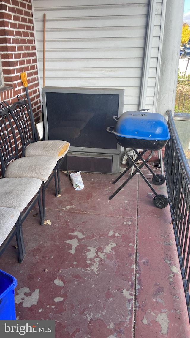 view of patio / terrace with a grill and a balcony