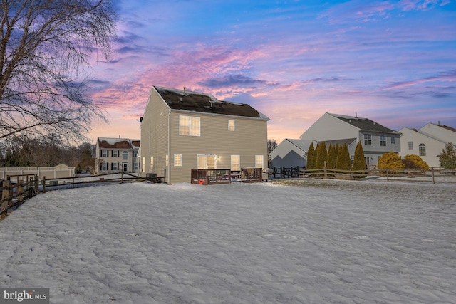 view of back house at dusk